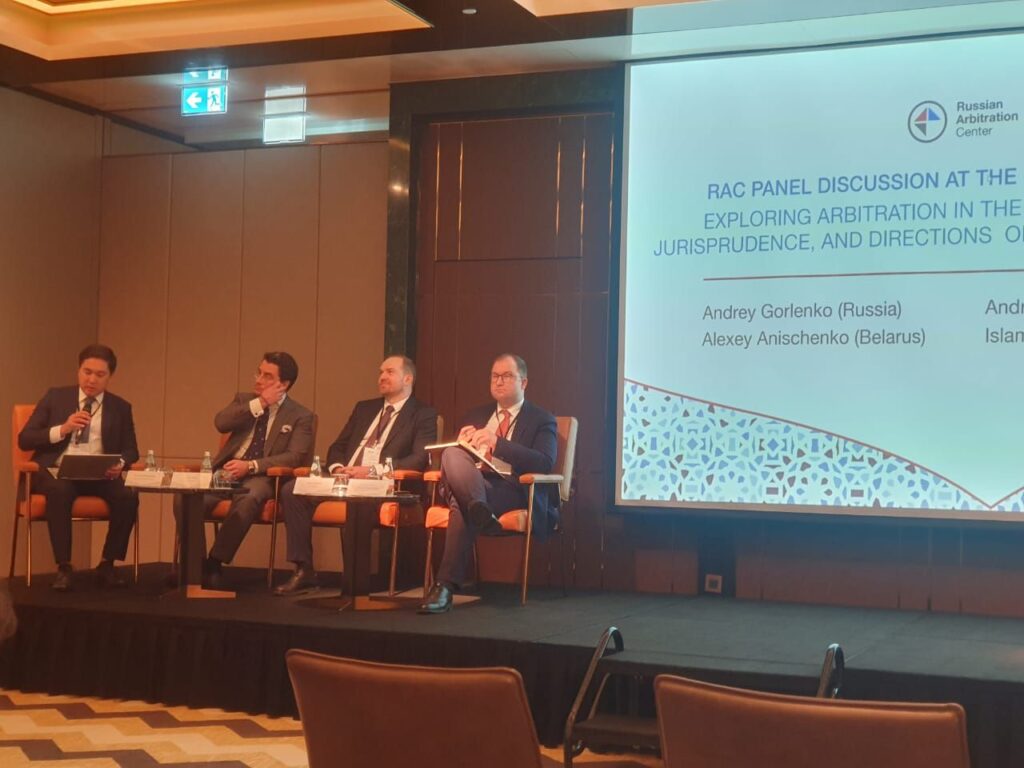 Four panellists seated on stage during the Russian Arbitration Center panel discussion at Dubai Arbitration Week 2023.