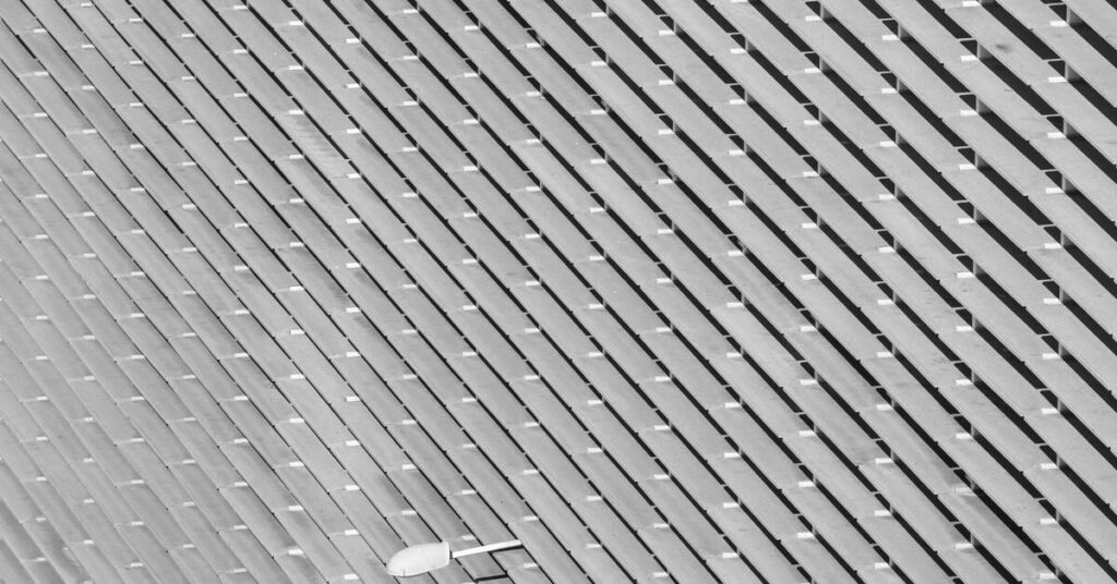 Diagonal ribbed architectural surface in greyscale