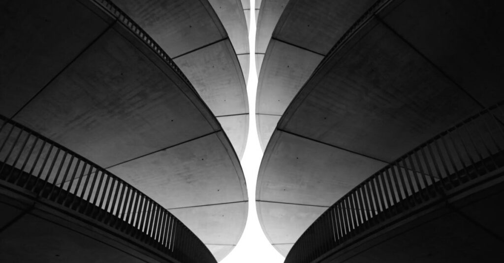 Symmetrical vaulted concrete ceiling in greyscale